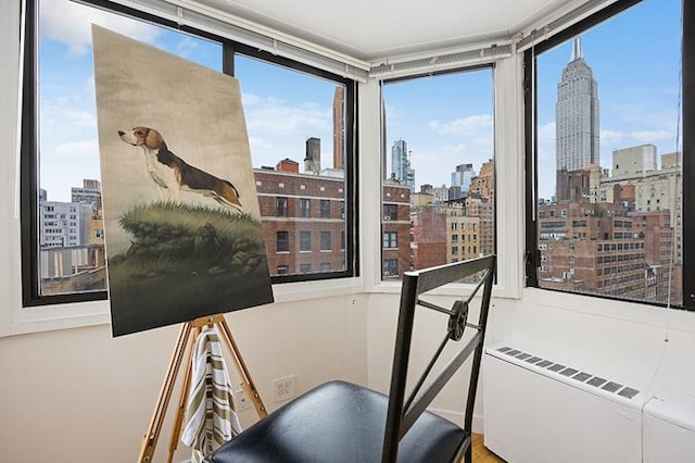 137 E 36th St Unit 11-B, New York City, NY 10016 - sunroom / solarium featuring a skyline view and radiator heating unit
