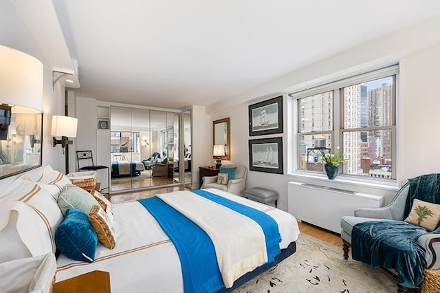 137 E 36th St Unit 11-B, New York City, NY 10016 - bedroom with radiator heating unit and wood finished floors