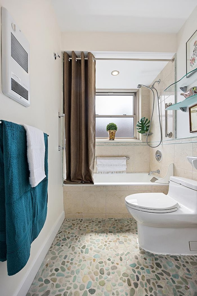 137 E 36th St Unit 11-B, New York City, NY 10016 - bathroom with tiled shower / bath, toilet, stone finish flooring, and heating unit