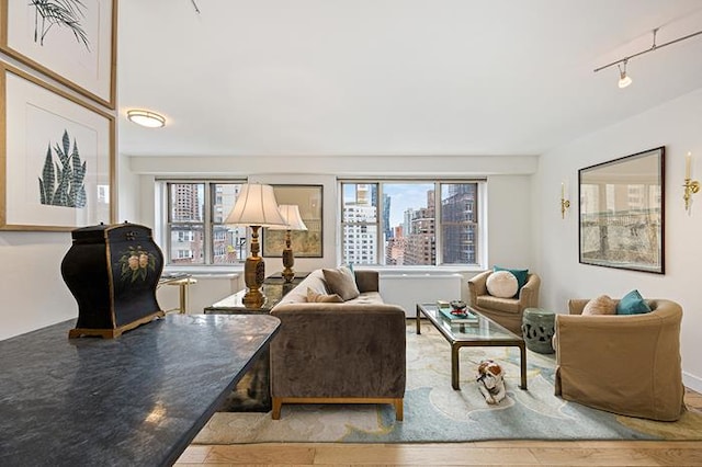 137 E 36th St Unit 11-B, New York City, NY 10016 - living room with healthy amount of natural light, track lighting, wood finished floors, and a view of city