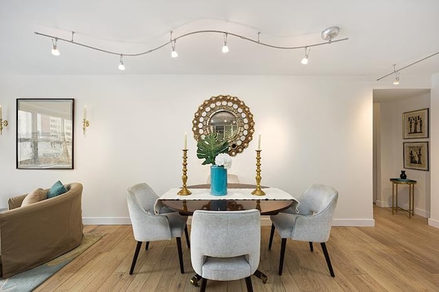 137 E 36th St Unit 11-B, New York City, NY 10016 - dining space featuring baseboards, light wood-style flooring, and track lighting