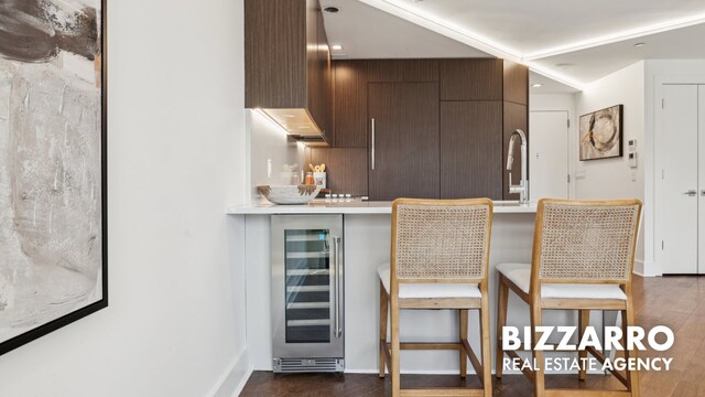 553 W 182nd St Unit 2R, New York City, NY 10033 - kitchen featuring wine cooler, a breakfast bar area, dark wood finished floors, and modern cabinets