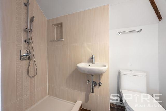 72-03 Ingram St Unit H0Use, New York City, NY 11375 - full bath with tiled shower, toilet, tile walls, and a sink