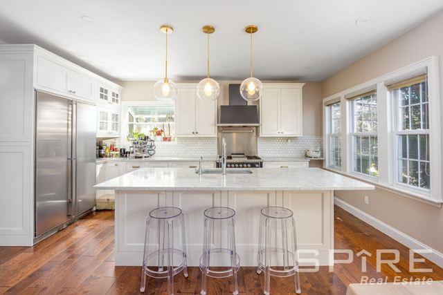 72-03 Ingram St Unit H0Use, New York City, NY 11375 - kitchen featuring built in fridge, wall chimney range hood, dark wood-style flooring, and a sink