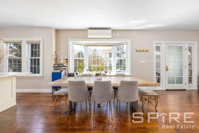 72-03 Ingram St Unit H0Use, New York City, NY 11375 - dining area with an AC wall unit, dark wood-type flooring, and baseboards