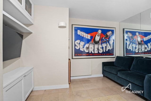 living room with baseboards and light tile patterned floors