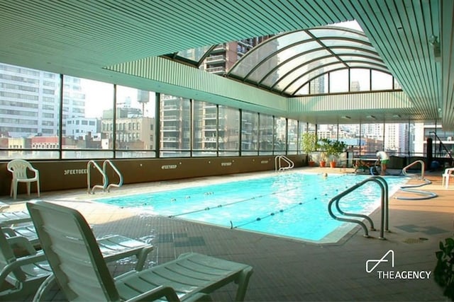 indoor community pool with a view of city