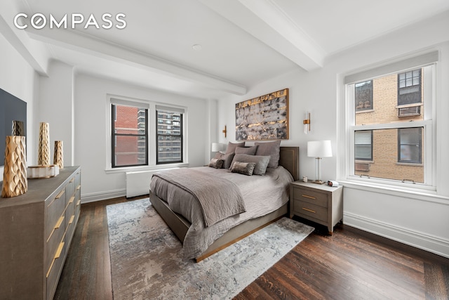 bedroom featuring baseboards, beam ceiling, and dark wood-style flooring