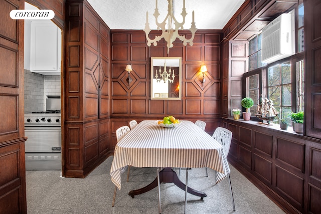 116 Pinehurst Ave Unit H14, New York City, NY 10033 - carpeted dining space with a chandelier and a decorative wall