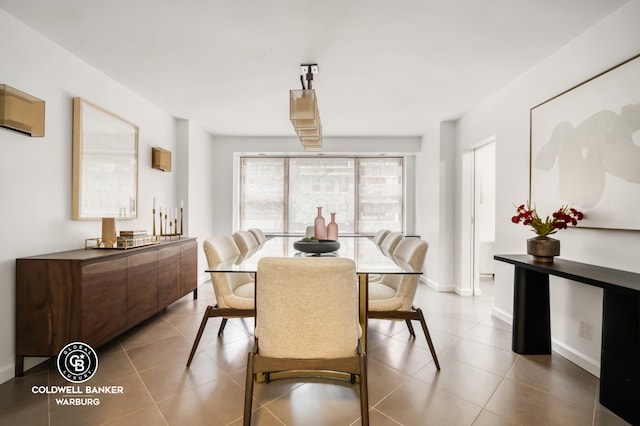 dining space with tile patterned floors and baseboards