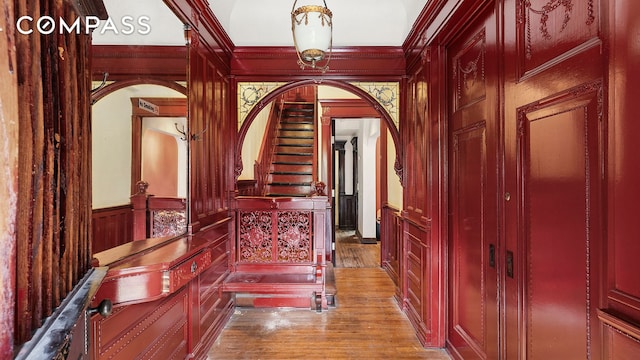 256 Decatur St, New York City, NY 11233 - corridor with arched walkways, wood finished floors, ornamental molding, wainscoting, and a decorative wall