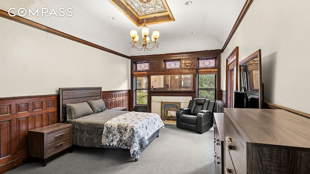 256 Decatur St, New York City, NY 11233 - carpeted bedroom featuring a chandelier, wainscoting, crown molding, a skylight, and a fireplace