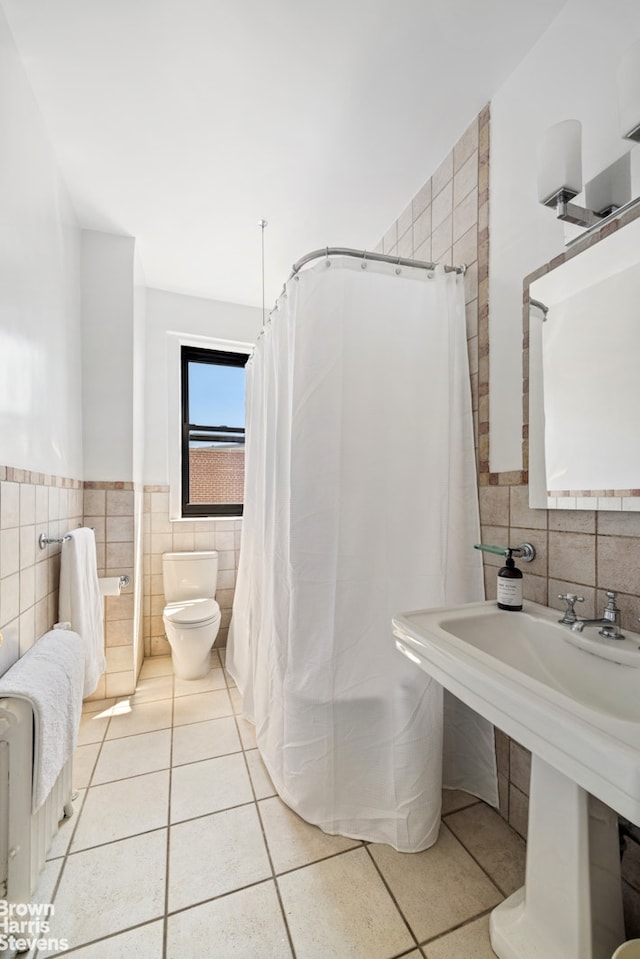 878 W End Ave Unit 16Cd, New York City, NY 10025 - full bath featuring tile walls, tile patterned flooring, toilet, a wainscoted wall, and curtained shower