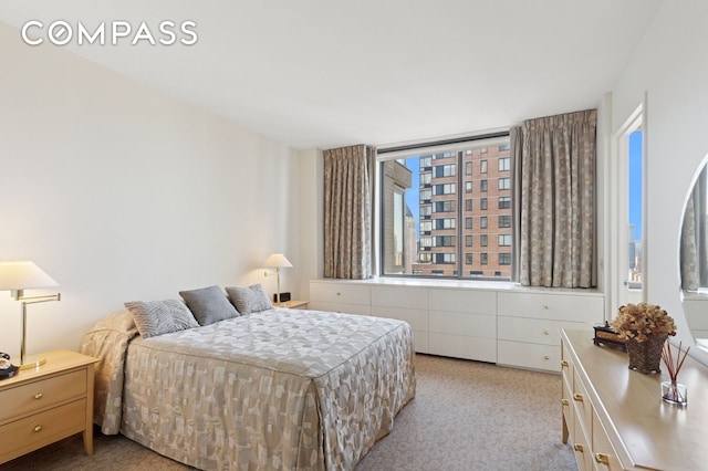bedroom with light colored carpet