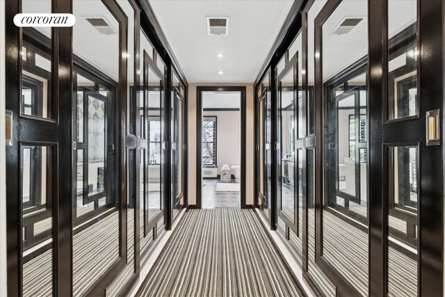 132 E 62nd St, New York City, NY 10065 - hallway featuring dark colored carpet and visible vents
