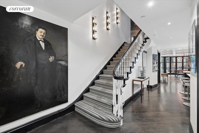 132 E 62nd St, New York City, NY 10065 - staircase featuring baseboards, wood finished floors, and recessed lighting