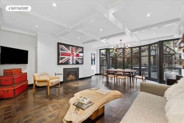 132 E 62nd St, New York City, NY 10065 - living room featuring a glass covered fireplace, a chandelier, coffered ceiling, baseboards, and visible vents