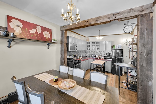 dining space featuring a chandelier and light wood-style floors