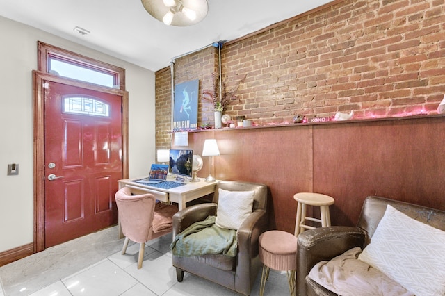 interior space with brick wall and tile patterned floors
