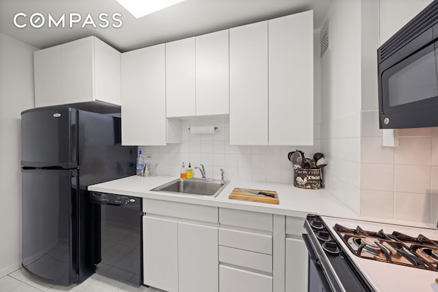 139 E 33rd St Unit 11L, New York City, NY 10016 - kitchen featuring black appliances, a sink, light countertops, white cabinets, and tasteful backsplash