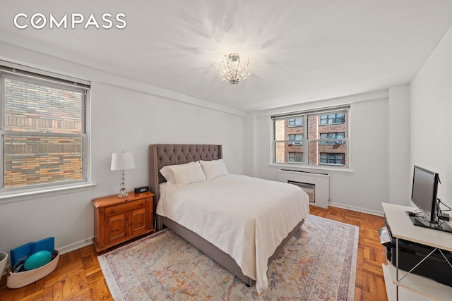 139 E 33rd St Unit 11L, New York City, NY 10016 - bedroom with multiple windows, baseboards, and a chandelier