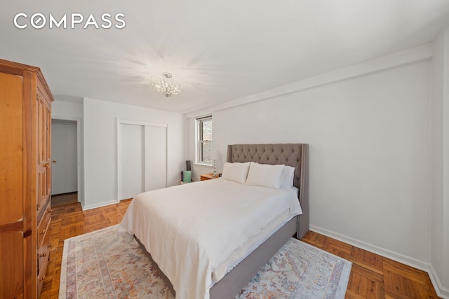 139 E 33rd St Unit 11L, New York City, NY 10016 - bedroom featuring a closet, a chandelier, and baseboards