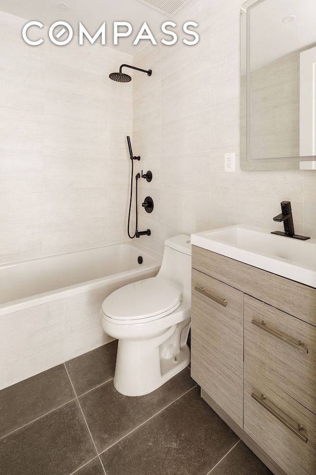 full bath featuring vanity, toilet, and tile walls