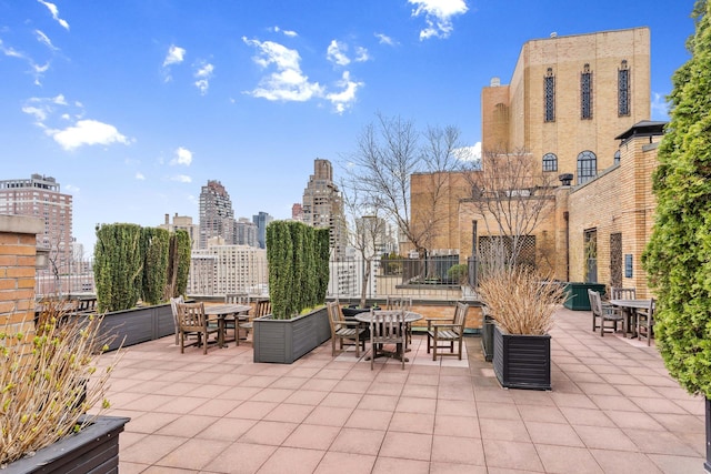view of patio featuring a city view and outdoor dining area