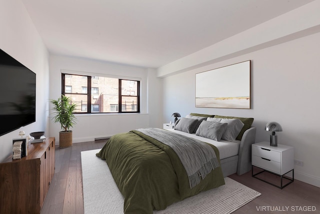 bedroom featuring wood-type flooring and baseboards