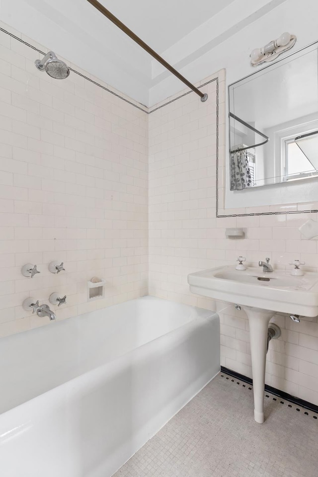 full bathroom featuring shower / bath combination and tile walls