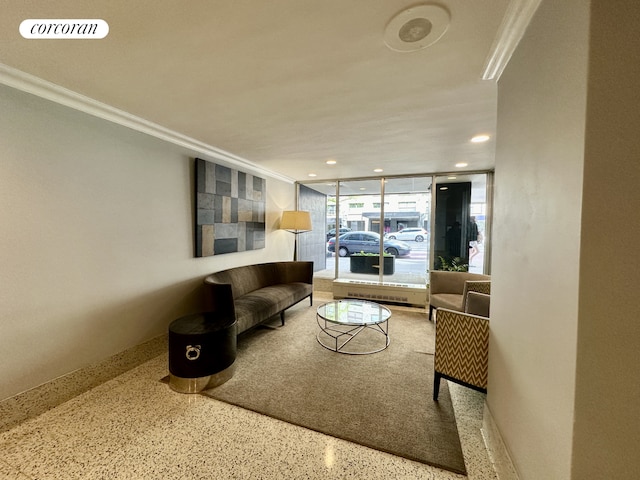 living area featuring speckle patterned floor, ornamental molding, and recessed lighting