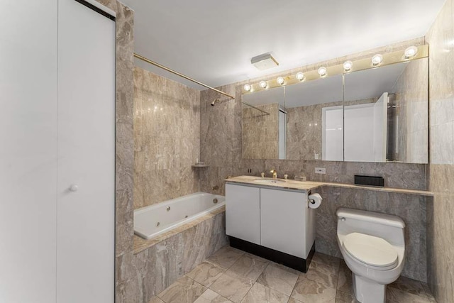 bathroom with marble look tile flooring, a combined bath / shower with jetted tub, toilet, vanity, and tile walls