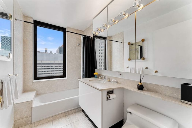 bathroom with toilet, shower / bath combo with shower curtain, vanity, and tile patterned floors