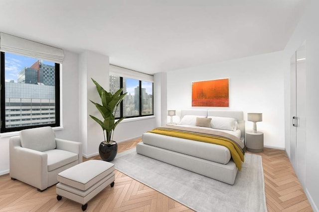 bedroom featuring baseboards and a city view