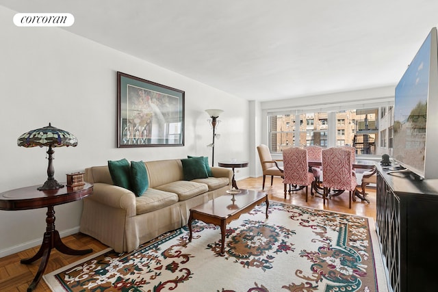 living area featuring baseboards