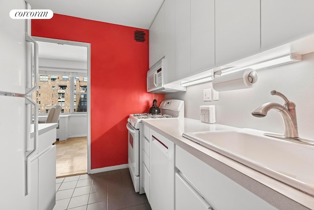 clothes washing area featuring light tile patterned flooring