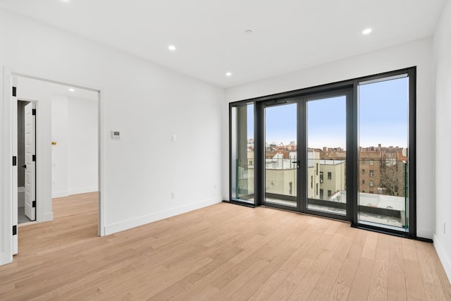 45-29 47th St Unit 2-B, New York City, NY 11377 - unfurnished room with light wood-style flooring, baseboards, and recessed lighting