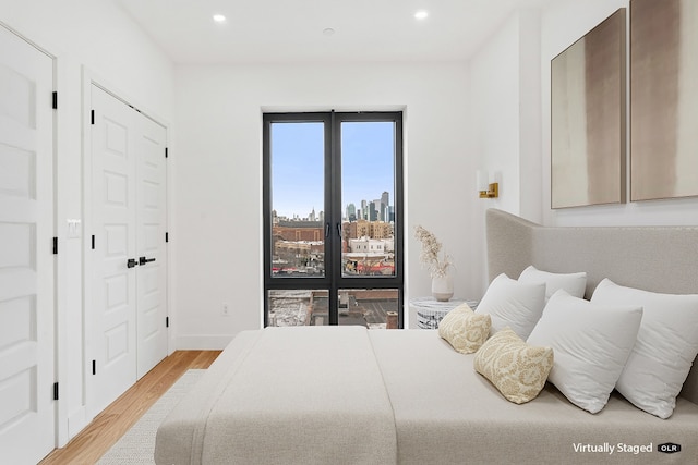 45-29 47th St Unit 3-A, New York City, NY 11377 - bedroom with wood finished floors, recessed lighting, baseboards, and a city view