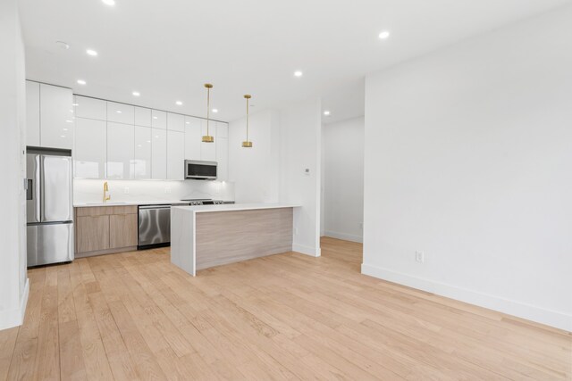 45-29 47th St Unit 3-A, New York City, NY 11377 - kitchen featuring appliances with stainless steel finishes, modern cabinets, light wood finished floors, white cabinets, and recessed lighting