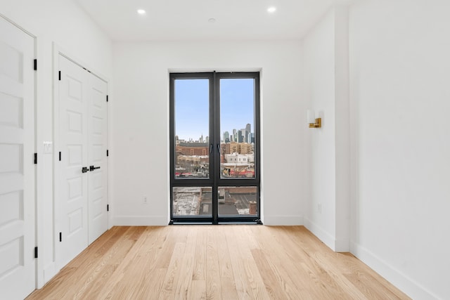 45-29 47th St Unit 3-A, New York City, NY 11377 - spare room with light wood finished floors, baseboards, recessed lighting, and a view of city
