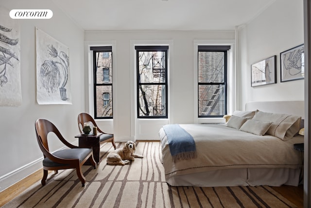 855 9th Ave Unit 1B, New York City, NY 10019 - bedroom featuring baseboards and wood finished floors