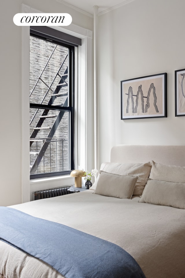 855 9th Ave Unit 1B, New York City, NY 10019 - bedroom featuring ornamental molding and radiator