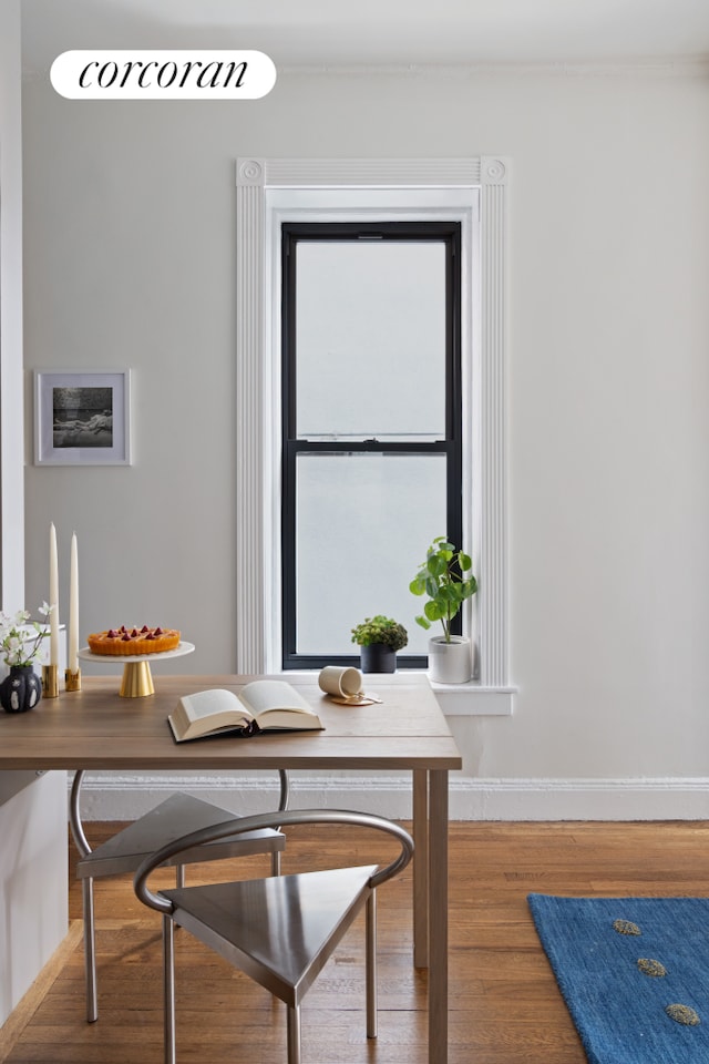 855 9th Ave Unit 1B, New York City, NY 10019 - dining room featuring a desk, baseboards, and wood finished floors