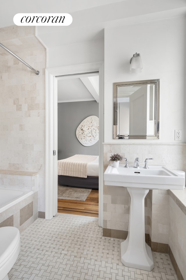 full bathroom with tiled shower / bath combo and ensuite bath