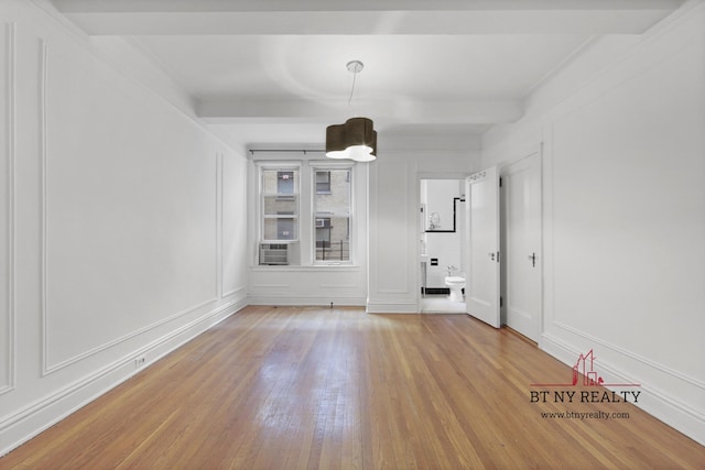 50 Riverside Dr Unit 11-F, New York City, NY 10024 - unfurnished room featuring light wood-style floors, a decorative wall, and beamed ceiling