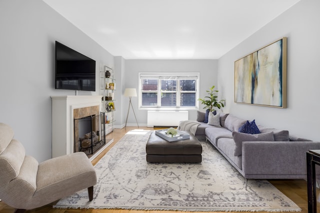 301 E 48th St Unit 14J, New York City, NY 10017 - living room with a fireplace, radiator, and wood finished floors