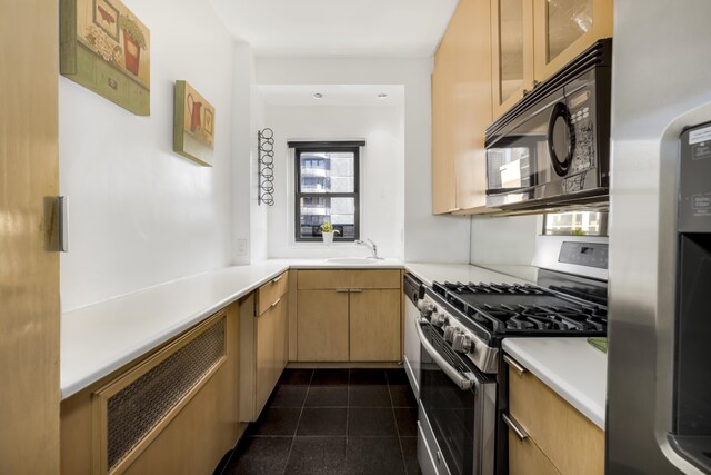 301 E 48th St Unit 14J, New York City, NY 10017 - kitchen featuring appliances with stainless steel finishes, light countertops, dark tile patterned flooring, glass insert cabinets, and a sink