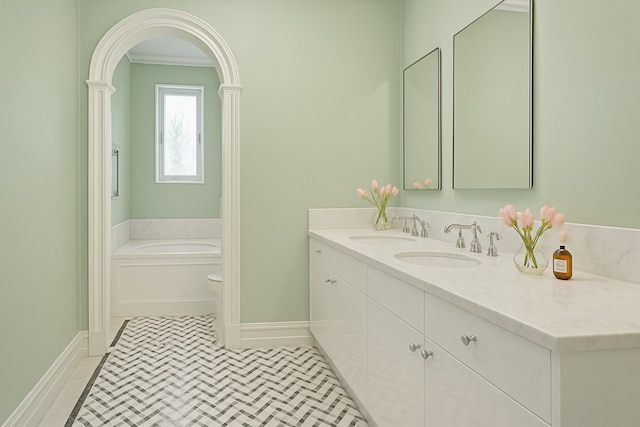 bathroom with vanity, baseboards, and a bath