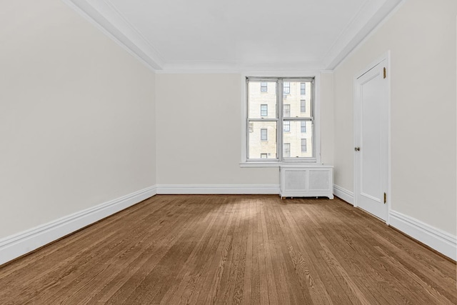 empty room with crown molding, baseboards, and dark wood-style floors