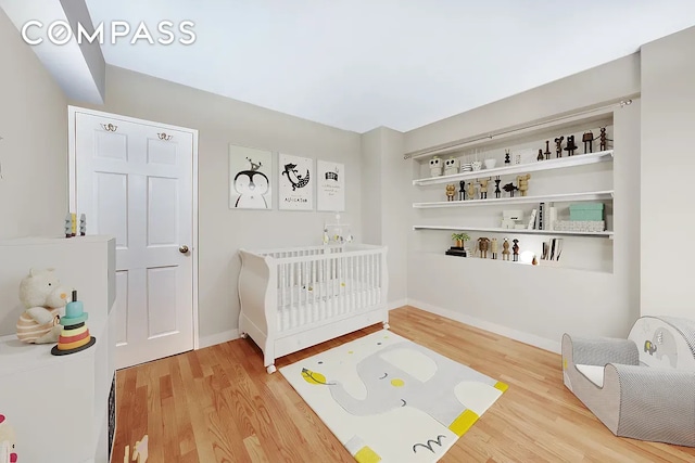 345 E 56th St Unit 5C, New York City, NY 10022 - bedroom featuring light wood finished floors and baseboards